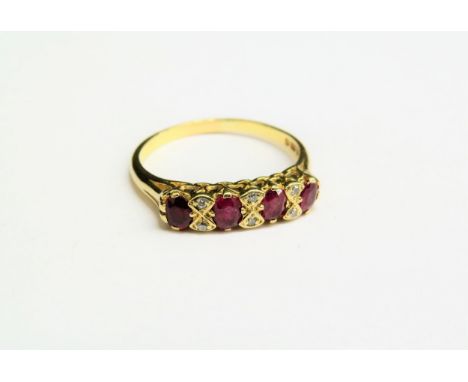 An 18ct gold diamond and ruby ten stone ring. Size S, 3.7g 