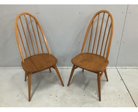 A pair of mid century Ercol elm and beech comb back dining chairs, height 96cm. Condition - fair to good, one with some damag