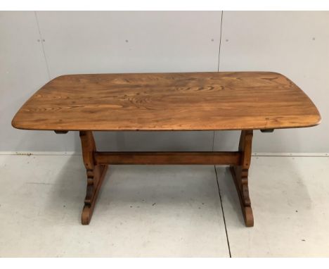 An Ercol elm topped dining table, width 150cm, depth 76cm, height 72cm and a set of four stained beech and elm dining chairs,