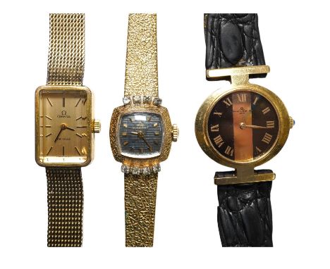 A ladies stylish Baume Mercier 18ct gold wrist watch, in original green leather case, and two gold plated wrist watches by Om