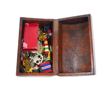 An assortment of WWI interest and other medals and related matter to include badges and brooches, some with enamel, housed in