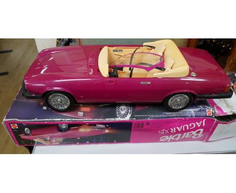 An early 1990s boxed Barbie Jaguar XJS car in pink. Condition fair to good, minor playwear and damage to the box.