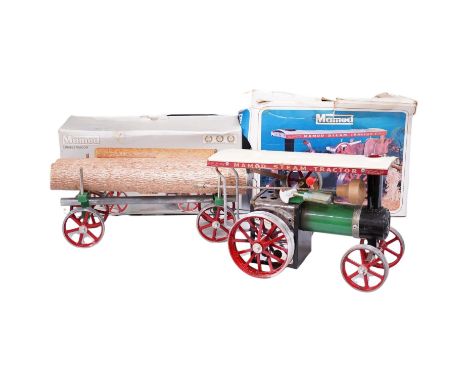 A boxed Mamod TE-1A live steam traction engine and lumber wagon. Condition - poor to fair, there is corrosion to the exposed 