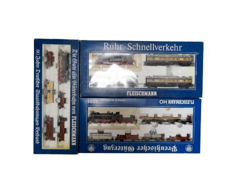 Three boxed Fleischmann HO gauge railway train sets; a passenger set with a 4-6-4T Loco and three clerestory coaches (4887), 