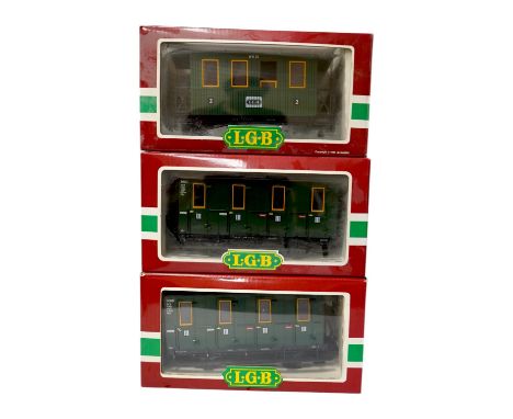 Four boxed Lehmann LGB G scale coaches; a bogie coach (3060), and three 4-wheel coaches (3106 and 2x 3050). Condition - good.