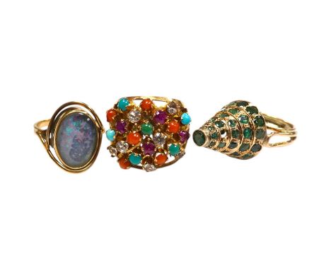Two Indian? yellow metal and gem set rings including emerald set conical shaped and one other yellow metal and simulated opal