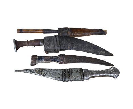 Three daggers, two with sheaths and a kukri knife, largest 33cm in length. Condition - poor