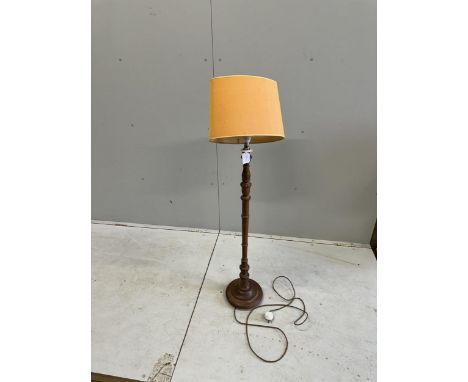 A 1930's turned oak standard lamp, height 97cm plus shade. Condition - good