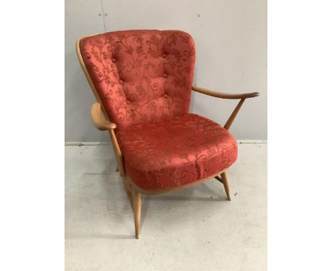 An Ercol golden beech armchair, width 73cm, height 82cm. Condition - rubbing to the tips of the arms, otherwise fair