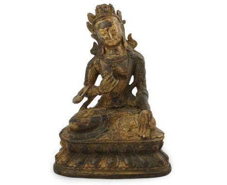 A Tibetan gilt bronze figure of seated Tara, on a double lotus throne, 16.5cm high.  Condition - good