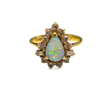 An 18k, white opal and round and baguette cut diamond set pear shaped cluster ring, size K/L, gross weight 4.6 grams. Conditi