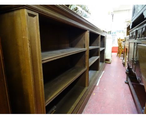 Polished wood three section multi-shelf bookcase, approx 3m long