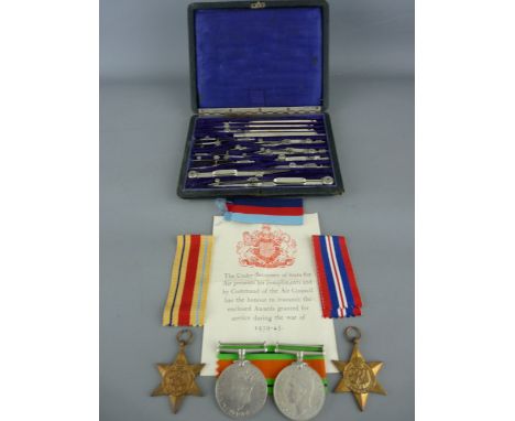 World War II group of four unmarked medals including a 1939-45 star, Africa star defence and victory with ribbons and paperwo