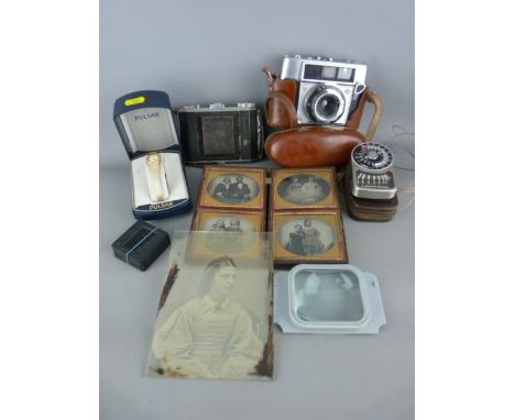Vulcanite book type frame holding four daguerreotype portrait images (damage to frame), two vintage cameras and a light meter