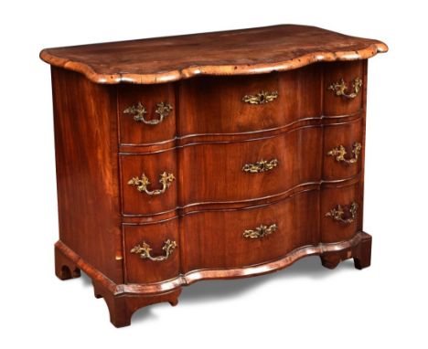 An 18th century Dutch walnut commode, of serpentine outline, crossbanded border decoration, with three long drawers, cast gil