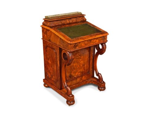 A mid-Victorian figured walnut Davenport desk, with raised galleried back enclosing letter compartments and pen tray, the lea