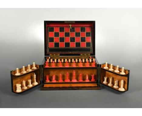 A 19th century Coromandel wood games compendium, the fitted interior including a stained and white ivory chess set, a set of 