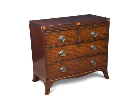 A George IV mahogany dressing chest, with an opening top to reveal compartments and dummy drawer facias, the frieze decorated