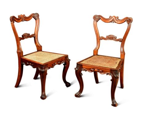 A pair of Gillows rosewood dining chairs, the shaped backs carved with shell and scroll, cane seats, on scroll carved legs, s