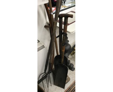 A collection of various vintage garden / agricultural tools to include scythes, two Lucas shovels, a stoneware flagon inscrib
