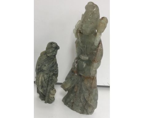 A Chinese fluorite carved figure of Guan Yin with vase in hand, 19.5 cm high, together with a Chinese carved soapstone figure