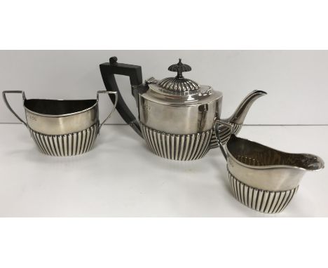 A Victorian silver miniature tea pot with semi reeded decoration (by Charles Boyton, London 1895) together with a matched cre