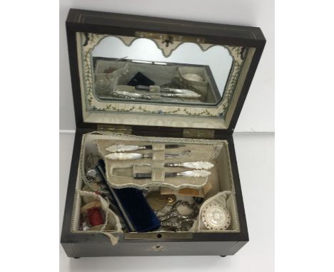 An early 19th Century mahogany brass and mother of pearl inlaid dome top sewing box with silk-lined fitted interior and vario