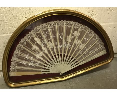A 19th Century painted stick and lace fan in a shaped box frame, frame size 40 cm x 64 cm together with six various prints, f