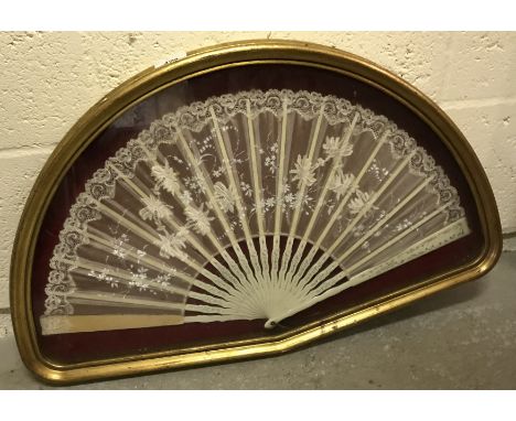 A 19th Century painted stick and lace fan in a shaped box frame, frame size 40 cm x 64 cm together with six various prints, f