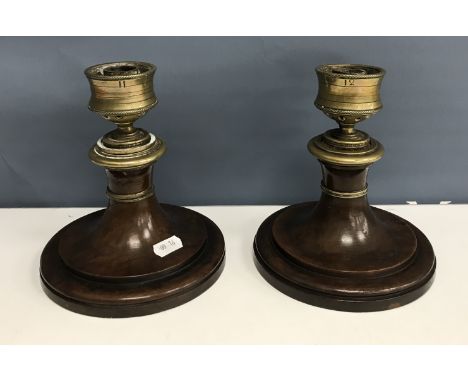 A pair of 19th Century brass and treen ware squat table candlesticks, 15 cm diameter x 16.5 cm high