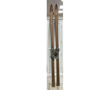 A pair of vintage wooden skiis with leather bindings bearing label "Meyer's Sportshouse andermatt" 224 cm long