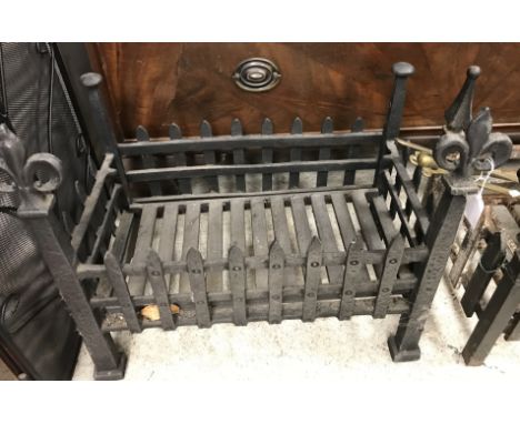 A cast iron fire grate with fleur de lys style finials, 57 cm wide x 30 cm deep x 48 cm high, together with a modern three-fo