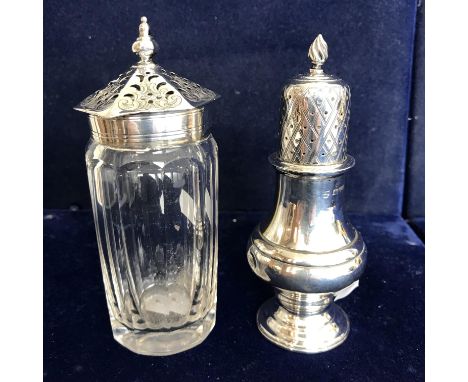 A George V silver baluster pepper in the 18th Century manner with pierced domed top and flaming torch finial over a bellied b