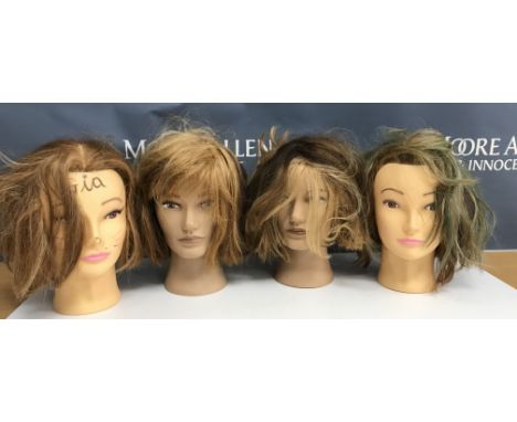 A collection of four mannequin/hairdressing heads, two inscribed "Pivot Point" to the necks