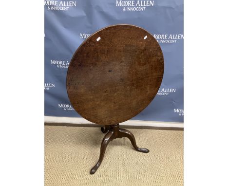 A late George III oak tea table the circular snap top on a turned pedestal to cabriole tripod base and pad feet, 74cm diamete