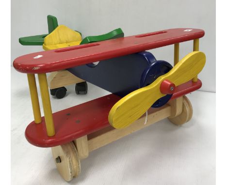 A collection of child's wooden painted ride on toys comprising a bi-plane, boat, dolphin and horse and a child's Knowle style