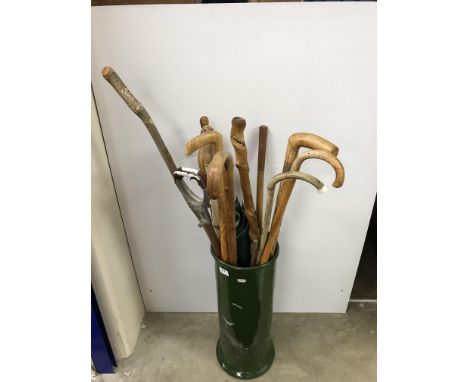 A pottery stick stand containing various walking sticks, canes, etc, including carved Scottish stick for D Robertson with scr