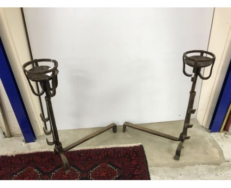 A pair of wrought iron ale muller fire dogs, 56 cm deep x 70 cm long, together with a collection of four various fire tools 