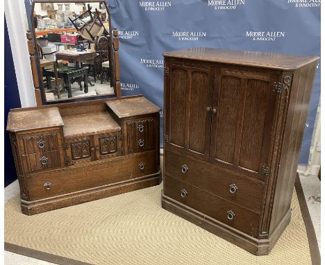 A mid 20th Century oak tallboy in the Gothic style with two cupboard doors above two drawers 85 cm wide x 47 cm deep x 119 cm