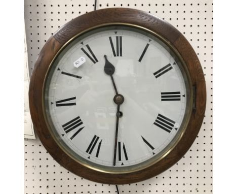 An oak cased wall dial clock, the white enamel dial set with Roman numerals, 38 cm diameter x 16 cm deep