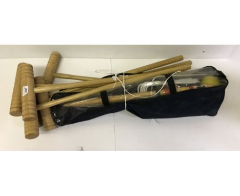 A child's croquet set, two wooden duck ornaments and a pair of fire dogs