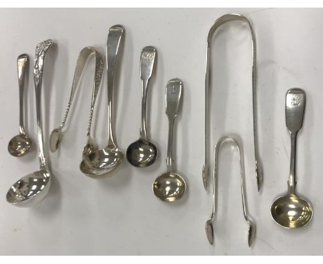 A collection of silver wares to include three sets of sugar tongs including a pair of Georgian tongs with bright cut decorati