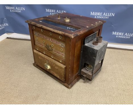 A vintage wooden framed incubator with transfer decorated front inscribed "Hearson's patent champion incubator" and "Propriet