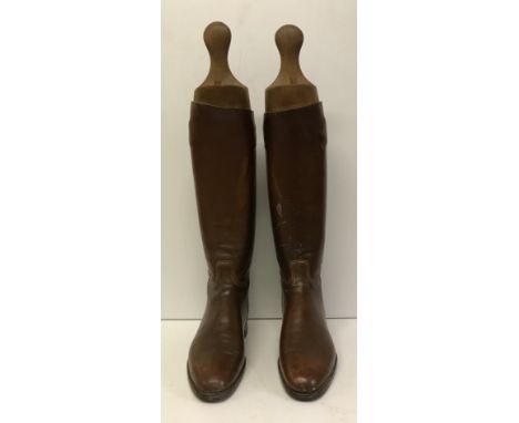 A pair of vintage brown leather hunting boots and trees