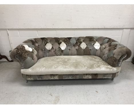 A modern patchwork buttoned upholstered Chesterfield sofa on silvered turned and reeded feet to castors, approx 215 cm wide x