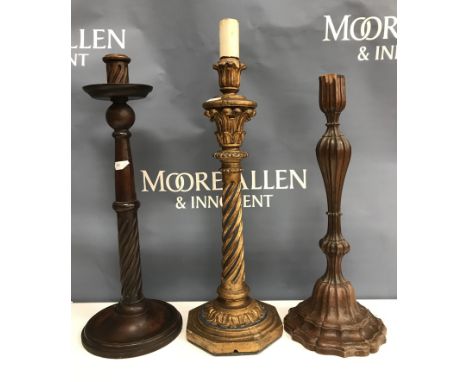 A 19th Century mahogany and carved candlestick of petal form 40.5 cm high, a mahogany turned and wrythen carved candlestick t