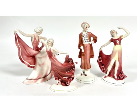 Katzhutte, a group of four Art Deco porcelain figures in pink including, a figure with arm upraised holding her evening dress