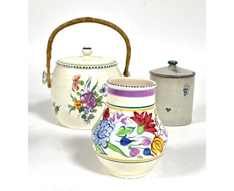 A Poole pottery 1930's biscuit barrel with wicker loop handle and floral sprays, (H x 16cm), a similar decorated vase and a j