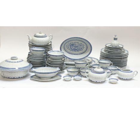 A large blue and white dinner service, with rice grain and dragon scene decoration comprising a tea pot, gravy boat and flat,