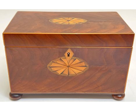 A Georgian mahogany veneered tea caddy on bun feet with inlaid escutcheon (h- 14cm, w- 21.5cm, d- 14cm)